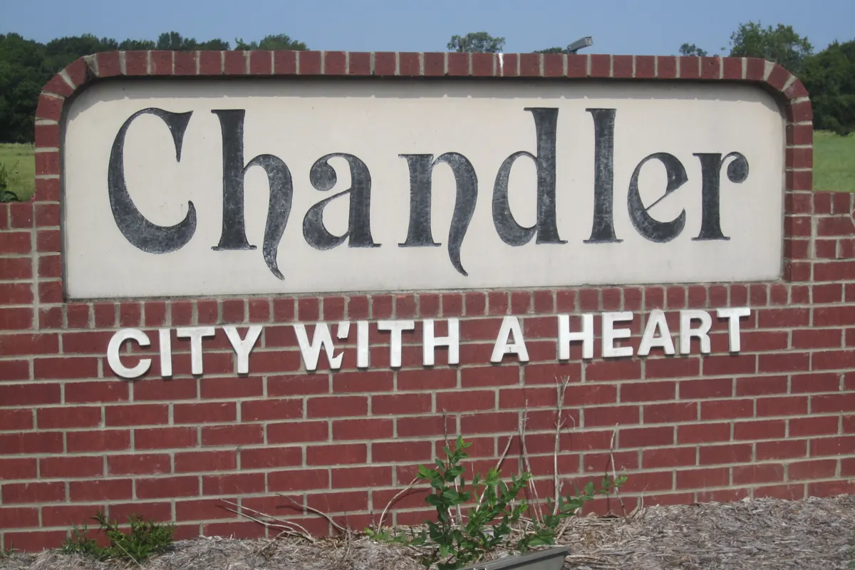 A brick welcome sign that reads Chandler, City With A Heart.